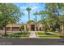 Charming single-story home with a landscaped front yard, mature trees, and a double door entrance at 2231 Chatsworth Ct, Henderson, NV 89074