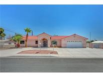 Charming single-story home with a red tile roof, manicured landscaping, and spacious driveway at 2398 S Lamont St, Las Vegas, NV 89104