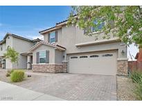 Charming two-story home featuring a neutral stucco exterior, a two-car garage and meticulously kept landscaping at 2486 Dragon Fire Ln, Henderson, NV 89052