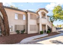 Charming condo featuring a two-story design with a staircase leading to the upper level entrance at 3066 Tarpon Dr # 204, Las Vegas, NV 89120