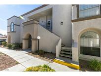 Attractive condo building exterior features stucco walls, arched windows, and a well-maintained landscape at 3150 Soft Breezes Dr # 2030, Las Vegas, NV 89128