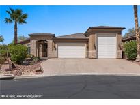 Charming single-story home features a three-car garage, stone accents and desert landscaping at 653 Paloma Cir, Mesquite, NV 89027