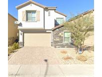 Charming two-story home featuring a two-car garage, brick driveway, and stone accents on the exterior at 6854 Chargehand Ave, Las Vegas, NV 89156
