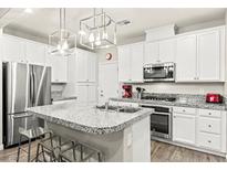 Modern kitchen features stainless steel appliances, granite countertops, and a stylish island with seating at 160 Lomita Heights Dr, Las Vegas, NV 89138