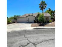 Charming single-story home featuring a low-maintenance yard, mature palm trees, and a two-car garage at 1785 Puerto Way, Henderson, NV 89012