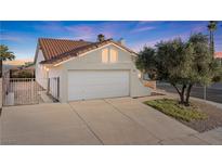 Inviting single-Gathering home featuring desert landscaping, two-car garage, and gated front yard at 2285 Carved Canyon Ln, Laughlin, NV 89029