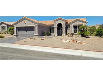 Charming single-story home with desert landscaping, covered entryway, and attached two-car garage at 2625 Youngdale Dr, Las Vegas, NV 89134