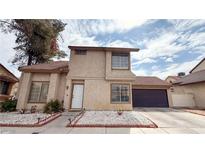 Charming two-story home with stucco siding, tile roof, attached garage, and manicured front yard at 2722 Sweet Basil Dr, Las Vegas, NV 89142
