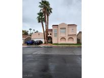 Two-story home with stucco walls and a red tile roof, complemented by mature palm trees at 2809 Du Barry Manor Ln, Las Vegas, NV 89108