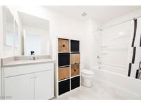 Bright bathroom featuring modern fixtures, storage, and a shower-tub combination at 3240 Avernus Ave, Henderson, NV 89044