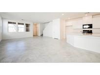 Bright, open-concept living space with tile flooring and large windows at 3240 Avernus Ave, Henderson, NV 89044