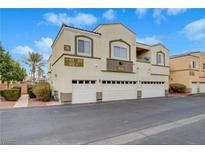 Two-story condo with a three-car garage, desert landscaping, and unit number visible at 3936 Pepper Thorn Ave # 102, North Las Vegas, NV 89081