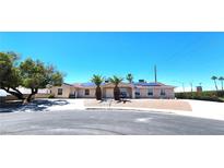 Charming single-story home featuring drought landscaping, a paved driveway, and solar panels on the roof at 4119 Meadowglen Cir, Las Vegas, NV 89121
