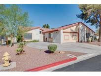 Charming single-story home with desert landscaping and a spacious driveway on a sunny day at 5242 Dickens Dr, Las Vegas, NV 89119