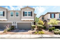 Attractive townhome with a two-car garage and manicured front yard landscaping at 6650 Drusilla St, North Las Vegas, NV 89084