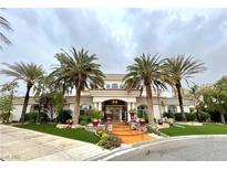 Stunning two-story home featuring lush landscaping, manicured grounds, and a circular driveway lined with mature palm trees at 7625 Coley Ave, Las Vegas, NV 89117