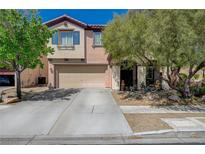 Two-story home with a two-car garage and drought-resistant landscaping at 7651 Anatolian St, Las Vegas, NV 89166