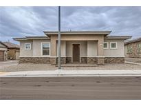 Charming single-story home featuring a brick-accented facade and neutral tones in a well-maintained neighborhood at 790 Sunny Sagebrush St, Henderson, NV 89011