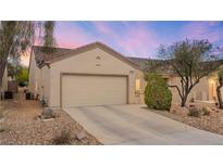 Charming single-story home featuring a neutral color palette, low-maintenance landscaping, and a two-car garage at 7934 Kiskadee St, North Las Vegas, NV 89084