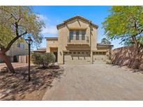 Charming two-story home featuring an attached three-car garage and a beautiful stone-paved driveway at 8029 Chablis Bay St, Las Vegas, NV 89131