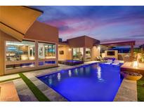 Stunning backyard with a sparkling blue pool, modern pergola, and outdoor seating, perfect for entertaining and relaxation at 819 Bolide St, Las Vegas, NV 89138