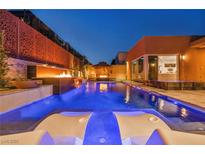 Inviting backyard pool with tanning ledge, lounge chairs, and fire feature, perfect for outdoor entertaining at 819 Bolide St, Las Vegas, NV 89138