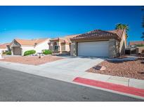 Inviting single story home featuring desert landscaping, tile roof, and a two car garage at 8901 Kingsmill Dr, Las Vegas, NV 89134