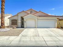 Charming single-story home with a well-maintained front yard and a two-car garage at 8940 Emery Lake St, Las Vegas, NV 89123