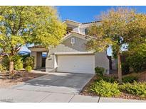 Charming two-story home featuring a neutral stucco facade, a red tile roof, and a two-car garage at 11132 Ferragamo Ct, Las Vegas, NV 89141