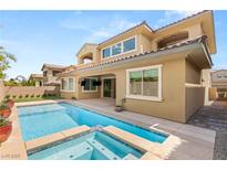 Relaxing backyard pool and spa combination with a covered patio perfect for outdoor living and entertaining at 12048 Portamento Ct, Las Vegas, NV 89138