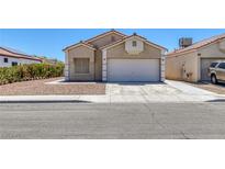 Charming single-story home with a two-car garage and low maintenance landscaping at 1213 Star Meadow Dr, North Las Vegas, NV 89030