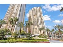 Stunning, luxury high-rise condos with lush landscaping and palm trees against a vibrant blue sky at 125 E Harmon Ave # 1905, Las Vegas, NV 89109