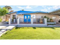 Charming home featuring a well-maintained lawn and inviting blue double door entrance at 1708 Weeping Willow Ln, Las Vegas, NV 89104