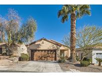 Inviting single-story home with a desert landscape, a palm tree, and a two-car garage at 2152 Mountain City St, Henderson, NV 89052