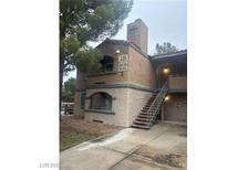 Charming condo building with stairs to the upper units in a well-maintained complex at 220 Mission Newport Ln # 201, Las Vegas, NV 89107