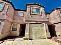 Charming townhome featuring stucco exterior, attached garage, and well-maintained landscaping at 2524 Charleville Ave # 102, Las Vegas, NV 89106