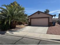 Charming single-story home with a two-car garage and a well-maintained desert landscaped yard at 2803 Exulted Valley Ave, North Las Vegas, NV 89032