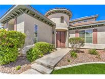 Beautiful home features a landscaped front yard and a circular tower design at the entrance at 3552 Coventry Gardens Dr, Las Vegas, NV 89135