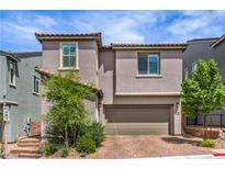 Charming two-story home featuring a well-maintained landscape and a two-car garage at 48 Verde Rosa Dr, Henderson, NV 89011