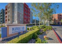 Manhattan Condominiums features colorful buildings, manicured landscaping, and clear signage at 50 E Serene Ave # 420, Las Vegas, NV 89123