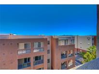 View of the exterior of the building with multiple balconies on a clear day at 50 E Serene Ave # 420, Las Vegas, NV 89123