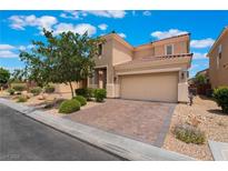 Charming two-story home boasts desert landscaping, a brick-paved driveway, and a two-car garage at 6412 Dimatteo St, Las Vegas, NV 89148