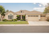 Charming single-story home with a well-manicured lawn, mature trees, and a two-car garage at 1100 Cypress Ridge Ln, Las Vegas, NV 89144