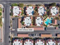 An aerial view showcases the community, parking, landscaping, and pool at 1751 E Reno #206 at 1751 E Reno Ave # 206, Las Vegas, NV 89119