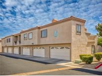Two-story condo building features attached garages and desert landscaping at 1851 Hillpointe Rd # 2124, Henderson, NV 89074