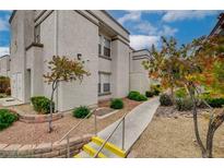 Charming condo featuring a landscaped walkway and steps, offering a welcoming approach to the building's entrance at 3150 Soft Breezes Dr # 2046, Las Vegas, NV 89128