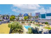 Inviting community pool with city views, lounge seating and mature landscape perfect for relaxation and entertainment at 3930 University Center Dr # 311, Las Vegas, NV 89119