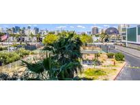Las Vegas community featuring pool, tennis courts, and shaded seating area with the city skyline in the background at 3930 University Center Dr # 312, Las Vegas, NV 89119