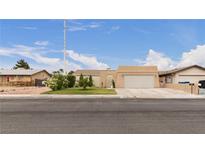 Charming single-story home with a two-car garage, desert landscaping, and inviting curb appeal at 4998 Rappahanock St, Las Vegas, NV 89122
