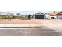 Charming single-story home with a well-maintained gravel yard and a convenient attached garage at 508 Van Dornum Ave, Henderson, NV 89011